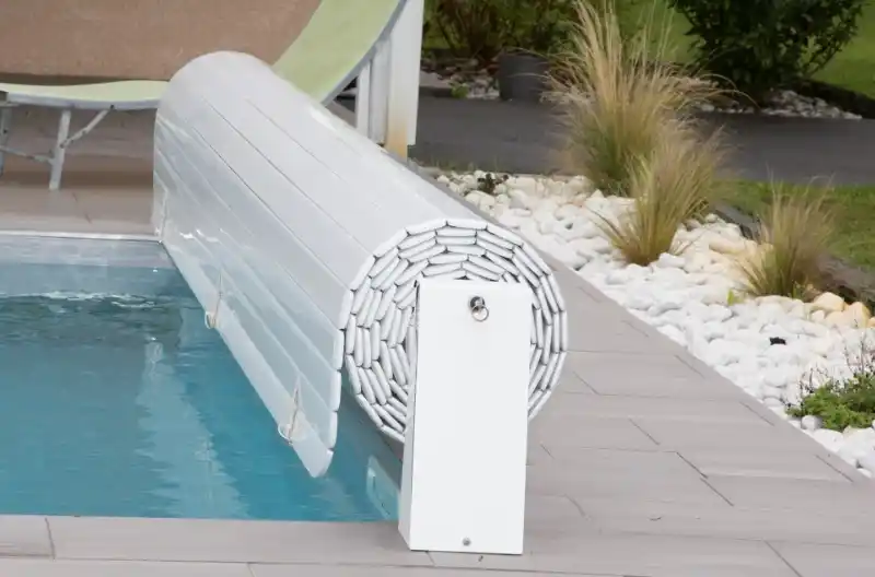 Hvidt poolcover rullet op ved poolkant, fokus på omkostningseffektive løsninger